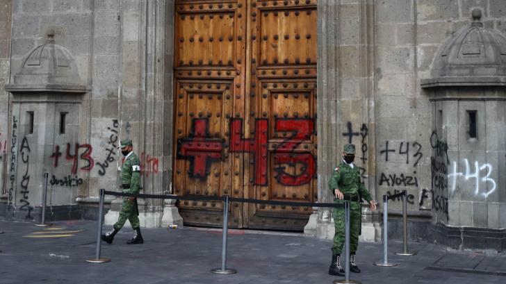 Hacen pintas en Palacio Nacional al concluir marcha por Ayotzinapa