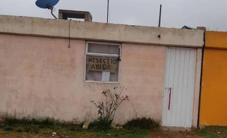 Con un letrero en la ventana, familia aislada por Covid-19 pide ayuda para sobrevivir