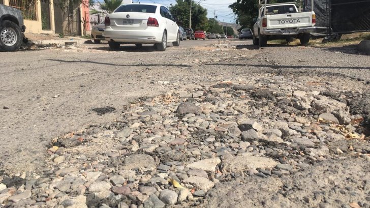 Es la única manera; vecinos llenan calles de escombros para tapar baches de Hermosillo